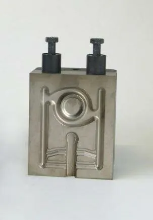 A metal test die with two vertical pins on top